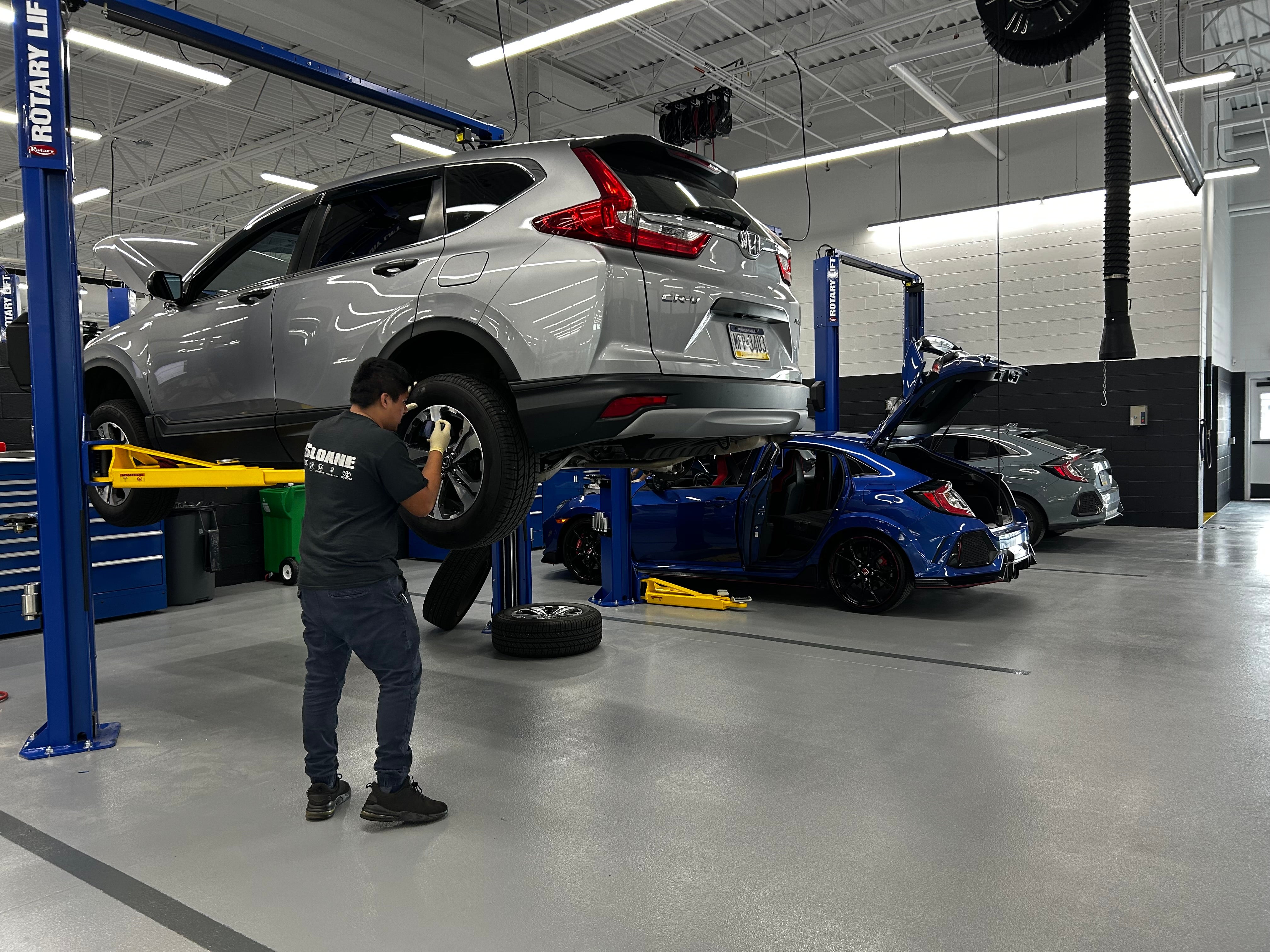 Sloane Honda Service Technician repairing a vehicle in the service center.